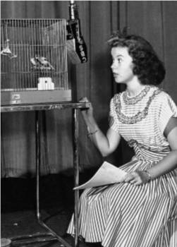 Hostess Shirley Temple hopes birds will sing in the air to fill a solider's "command"